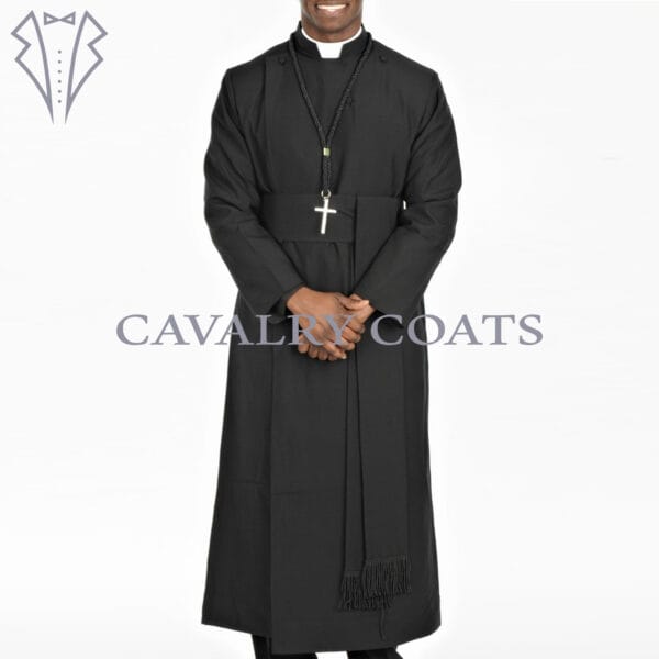 A black Anglican clergy robe cassock with a matching cincture belt. The robe is long-sleeved and floor-length, featuring traditional button-up closure and a standing collar. The cincture belt is tied around the waist, completing the clerical attire.