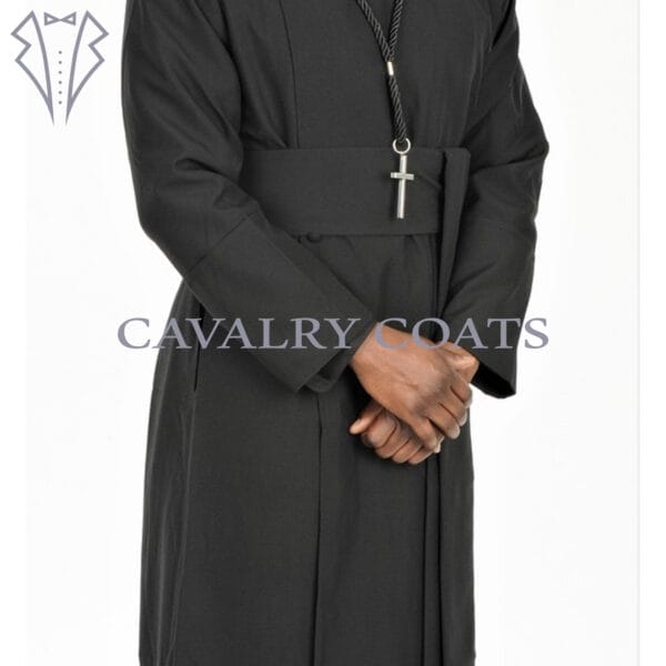 A black Anglican clergy robe cassock with a matching cincture belt. The robe is long-sleeved and floor-length, featuring traditional button-up closure and a standing collar. The cincture belt is tied around the waist, completing the clerical attire.