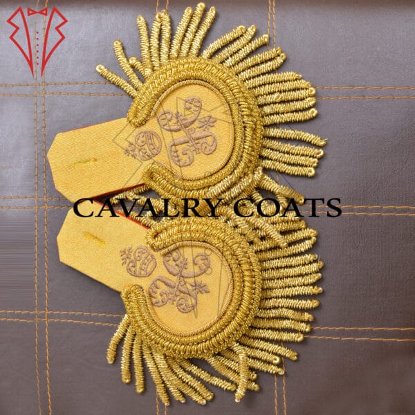 "Golden military epaulettes featuring intricate designs and symbols, worn on the shoulders of a uniform. The epaulettes signify rank and authority within the armed forces."