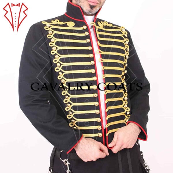 A Hussar canvas military-style fitted jacket, featuring a high collar and intricate brass button detailing along the front. The jacket is tailored with a slim fit, highlighting the wearer's silhouette. It has shoulder epaulets and decorative piping, adding to its historic military aesthetic. The fabric appears to be sturdy canvas, giving the jacket a rugged yet polished look.