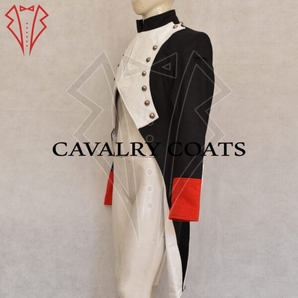 A detailed 18th-century Napoleonic uniform features a dark blue military jacket with red and gold trim, adorned with brass buttons. The jacket has epaulettes on the shoulders, indicating rank. The soldier wears white breeches, knee-high black boots, and a bicorne hat with a feather plume, symbolizing the grandeur of the Napoleonic era.